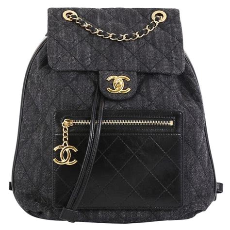 chanel calfskin backpack embellished with a cc signature|small black quilted Chanel bag.